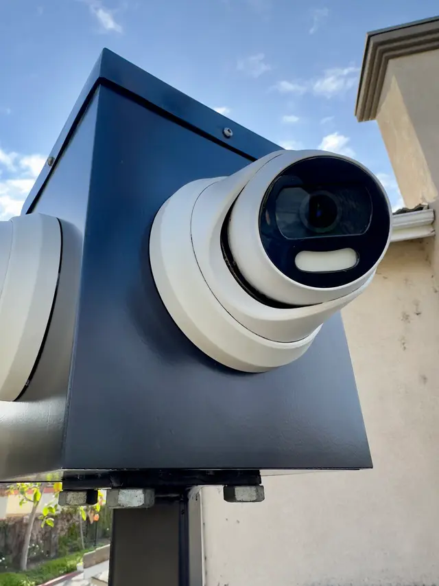 AI turret security camera installed under an eave