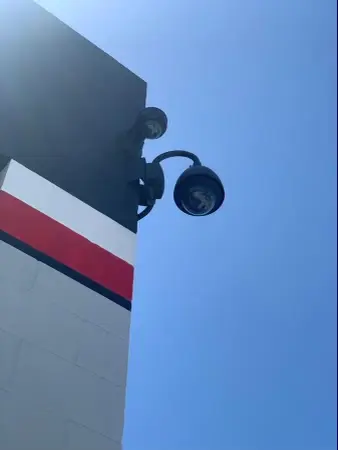 Bullet security camera corner-mounted on a commercial building