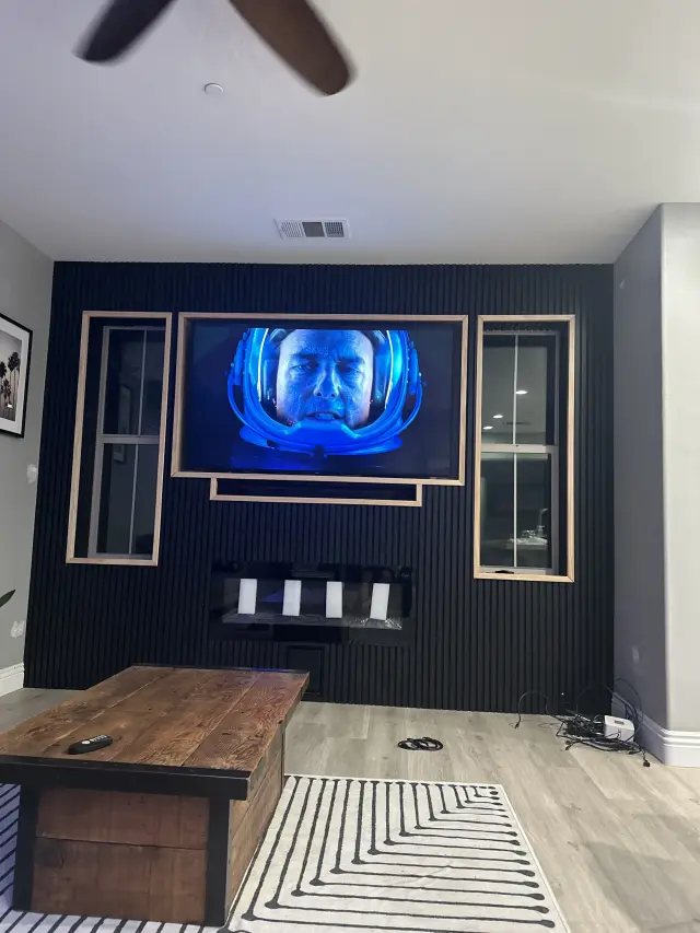 Custom audio visual feature wall installation with integrated television and sound system