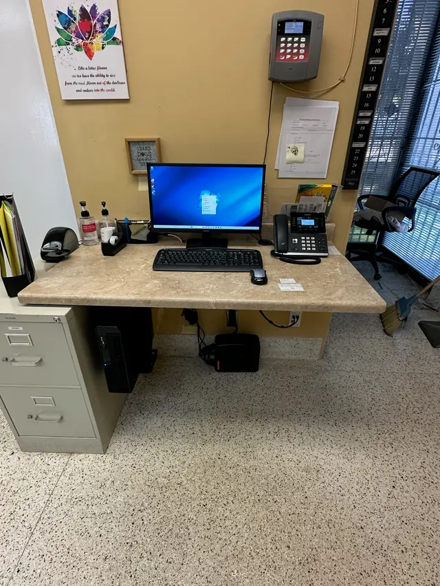 After: clean workstation with monitor and phone, all cabling managed