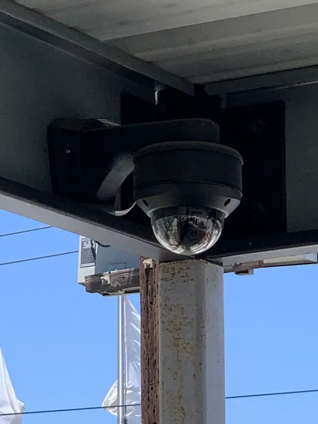 Dome security camera mounted under a drive-through canopy