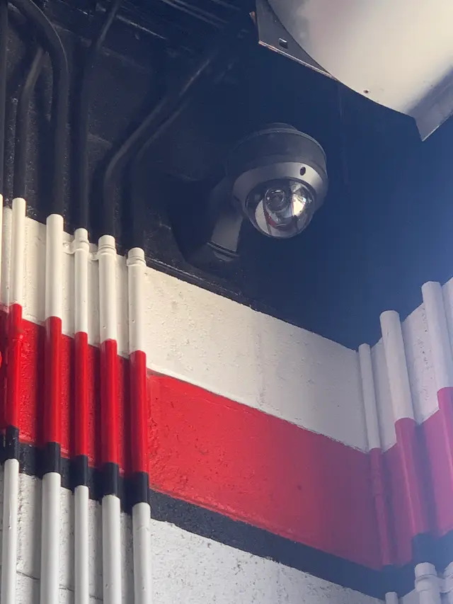 Dome security camera installed at a commercial storefront
