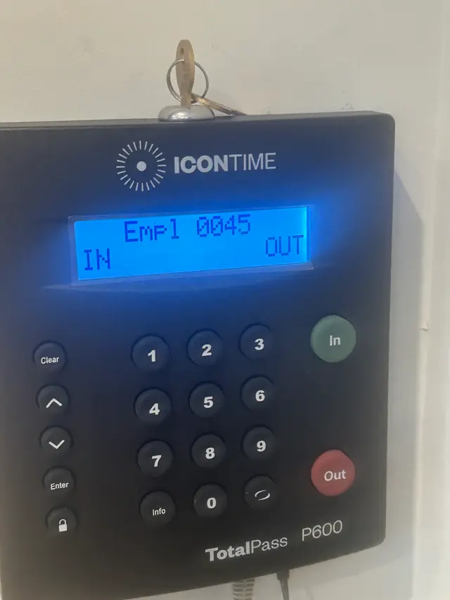 Employee time clock configured for badge-in and badge-out tracking
