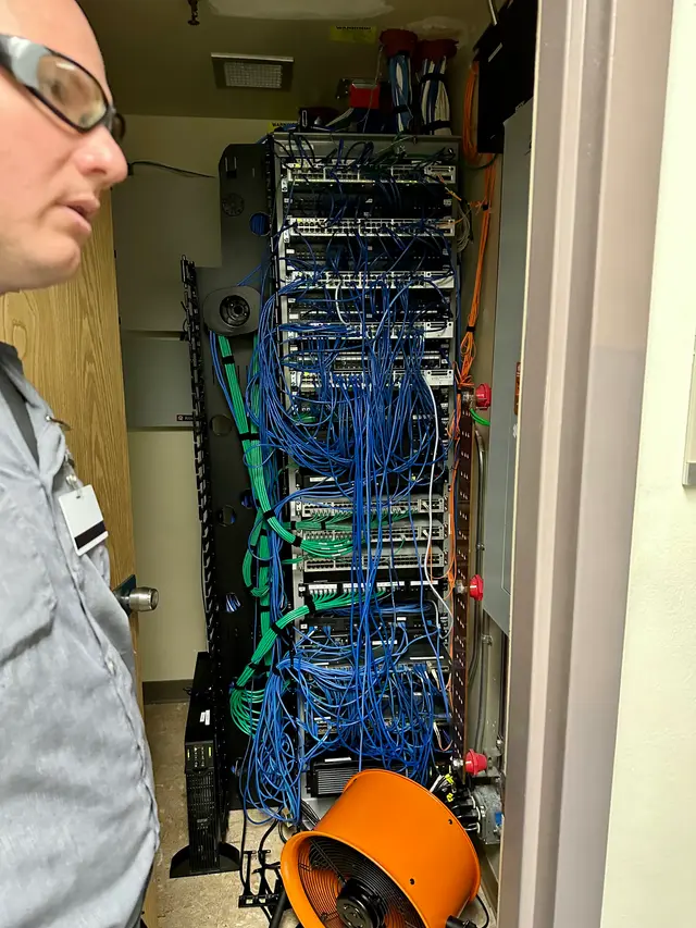 Severely tangled network rack the way CoreConnectIT found it on a cleanup call