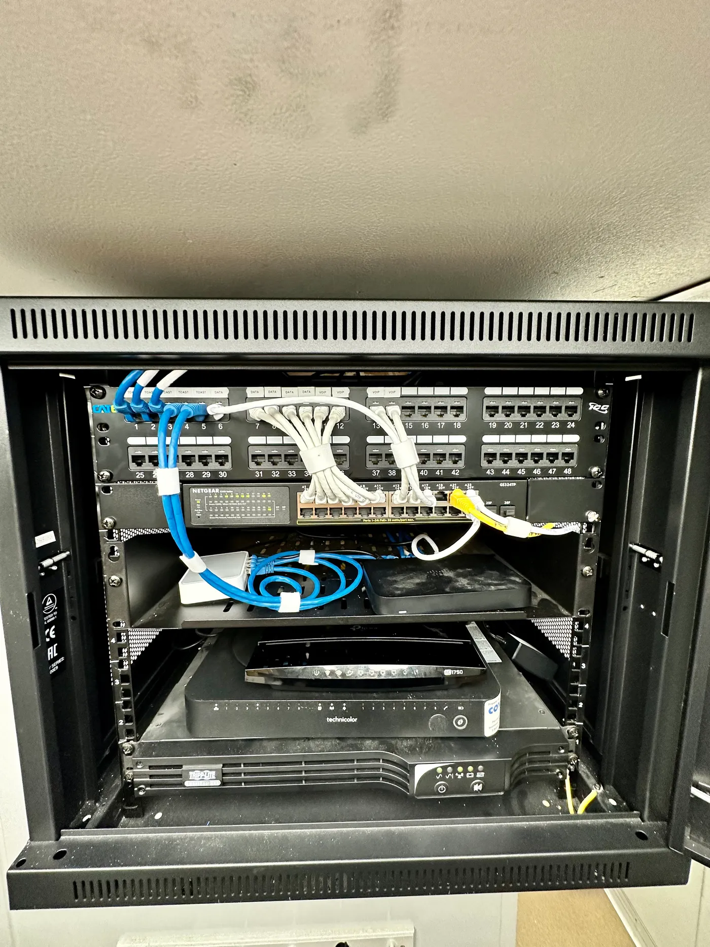 Organized network rack after a CoreConnectIT cable cleanup