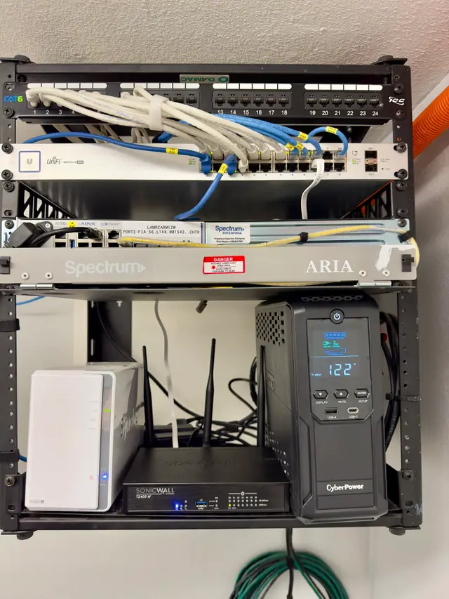 Network rack with labeled equipment and UPS battery backup installed