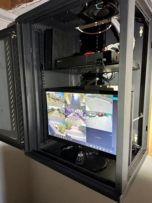 Equipment rack with NVR and live security camera monitoring display