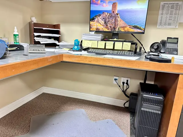 Office computer setup with monitor riser and tidy cabling