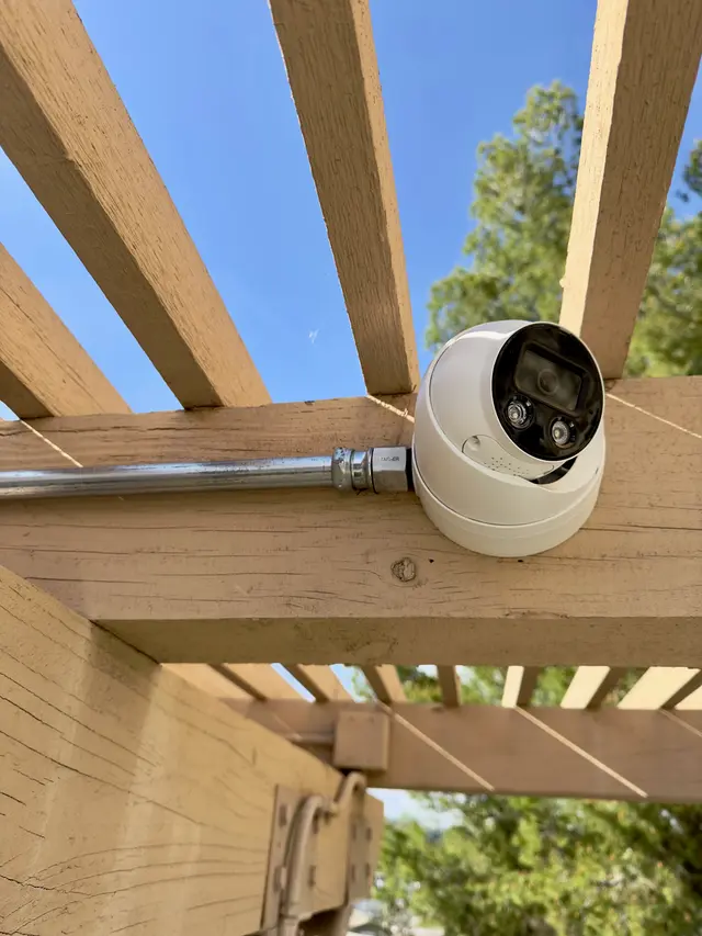 Outdoor turret camera installed on a residential pergola
