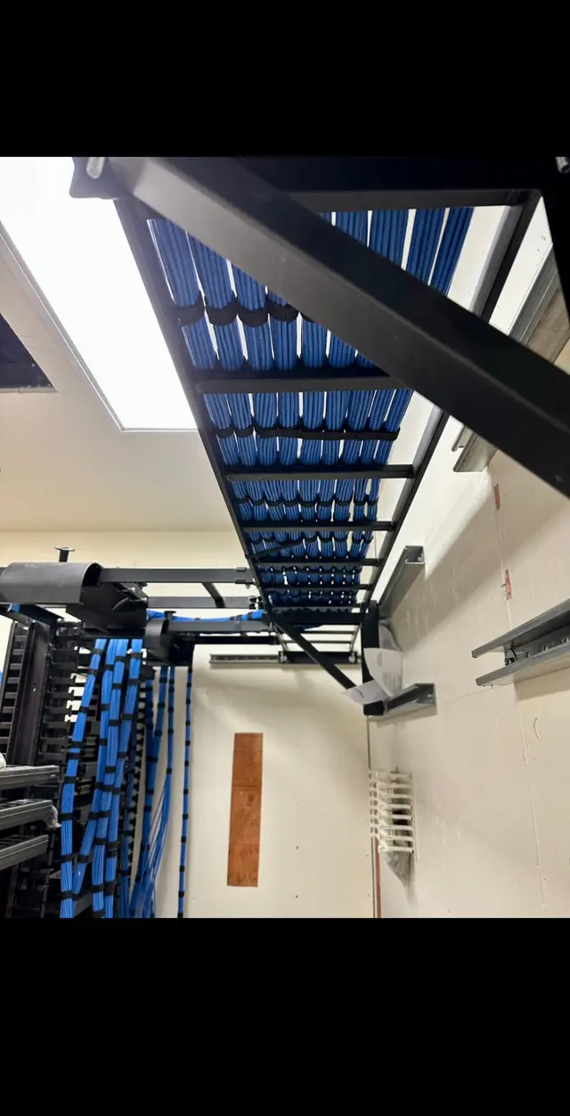 Overhead cable tray routing Cat6 bundles into an IDF rack