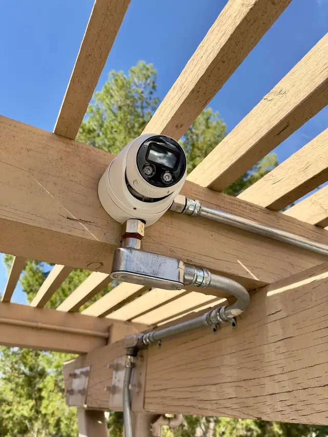 Turret camera installed on a pergola with a clean conduit run