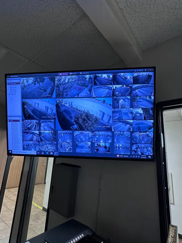 Wall-mounted display showing live views from a multi-camera commercial security system