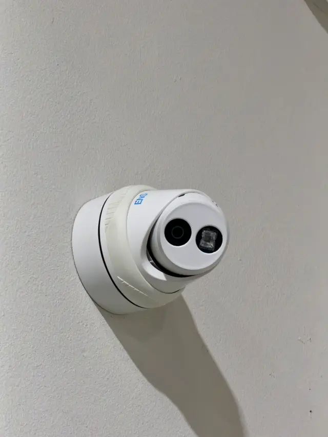 White turret camera wall-mounted with concealed cabling