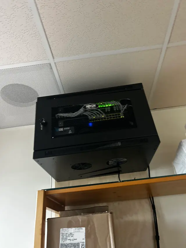 Compact wall-mount network cabinet installed and cabled
