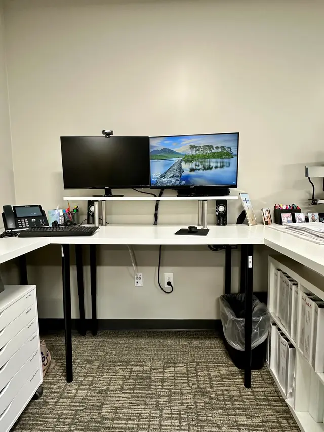 Wall-mounted dual monitors with webcam for a clean desk setup