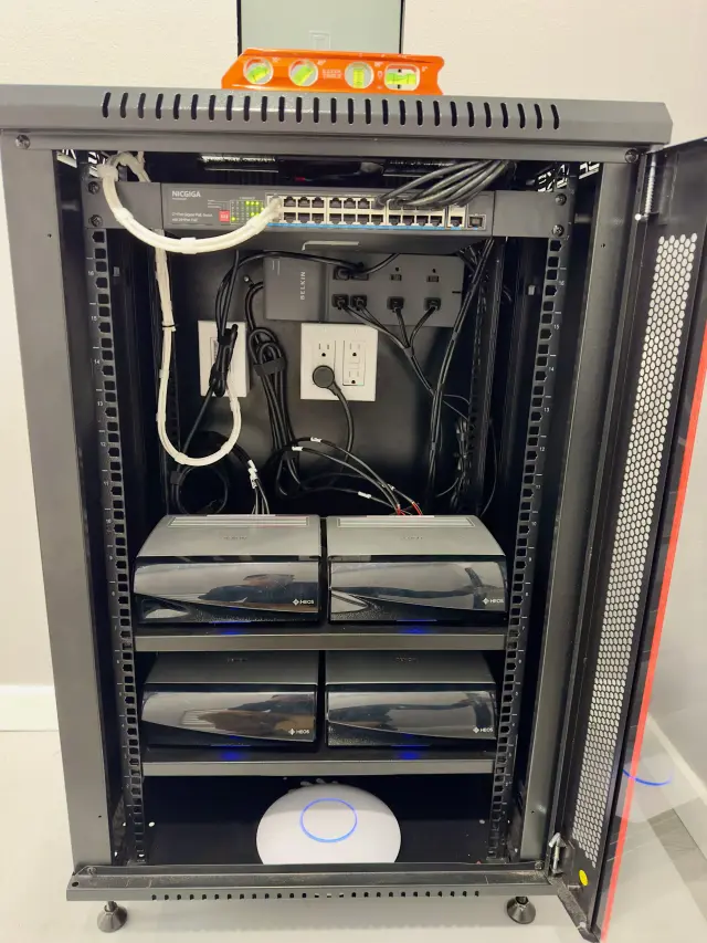 Whole-house audio system rack installation featuring distributed Sonos audio components